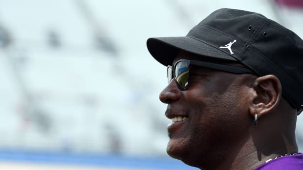 Michael Jordan wearing a black hat with Jumpman logo.